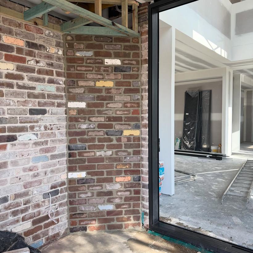 Brick panel with mitred corners built to hide pipework