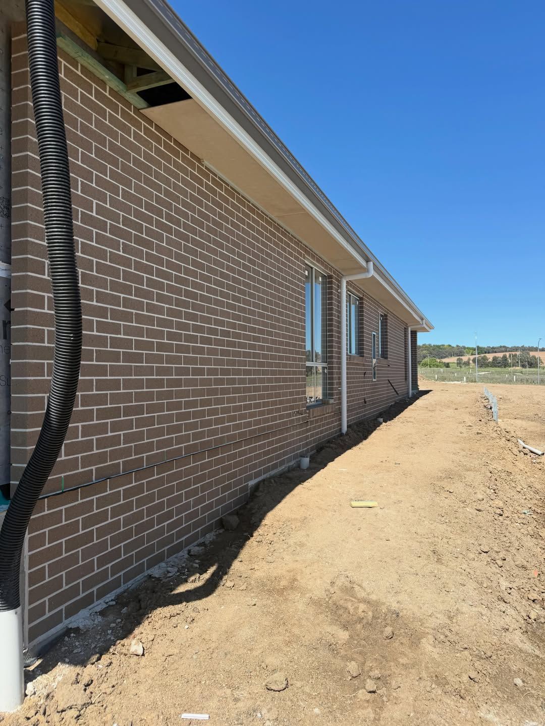 Long face-brick veneer wall on a new home
