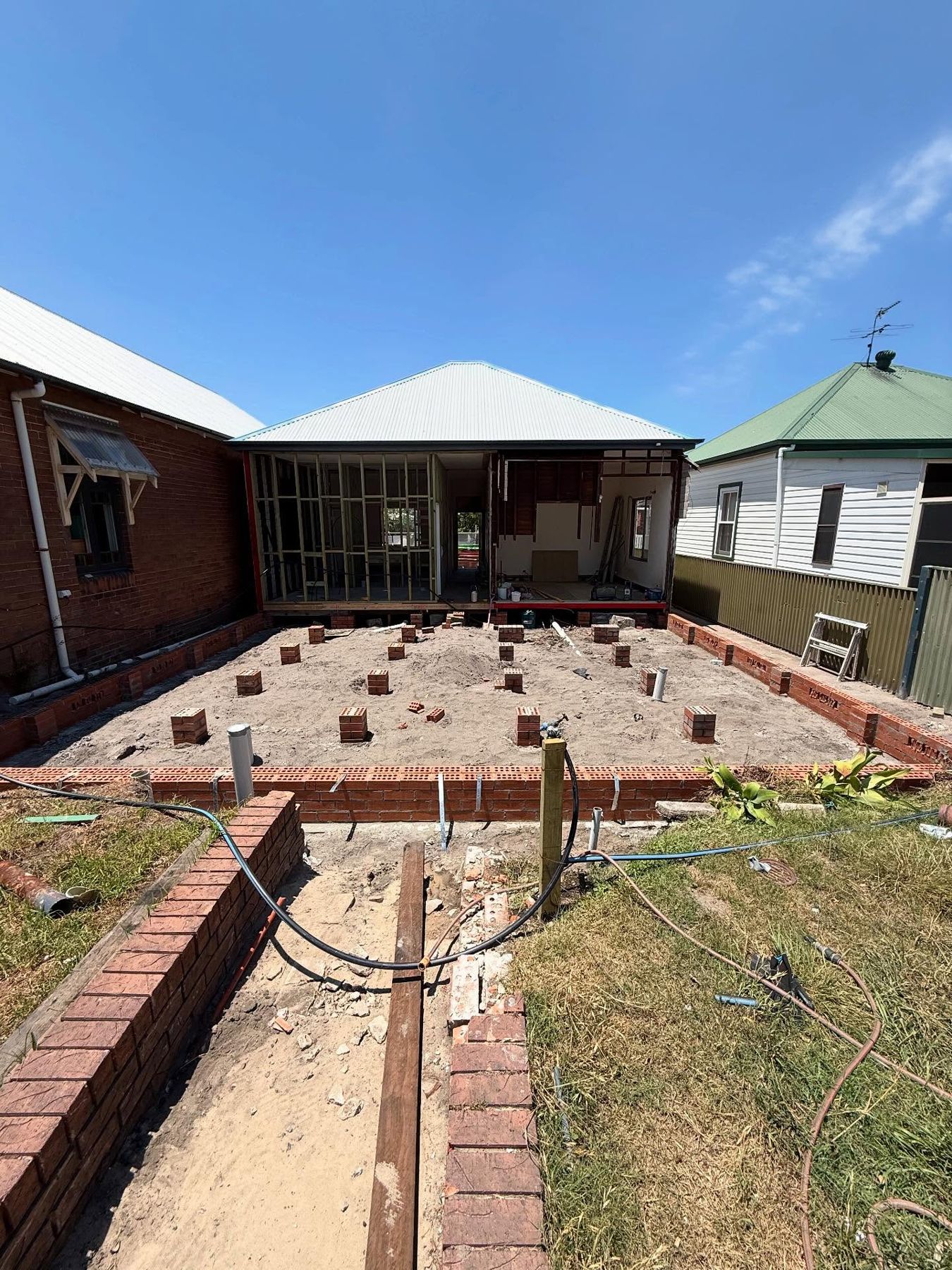 Brick subfloor and piers for a rear extension behind a weatherboard home